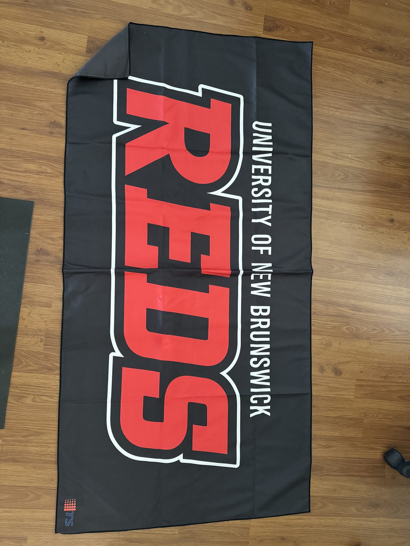 Custom printed UNB Reds towel, full colour
